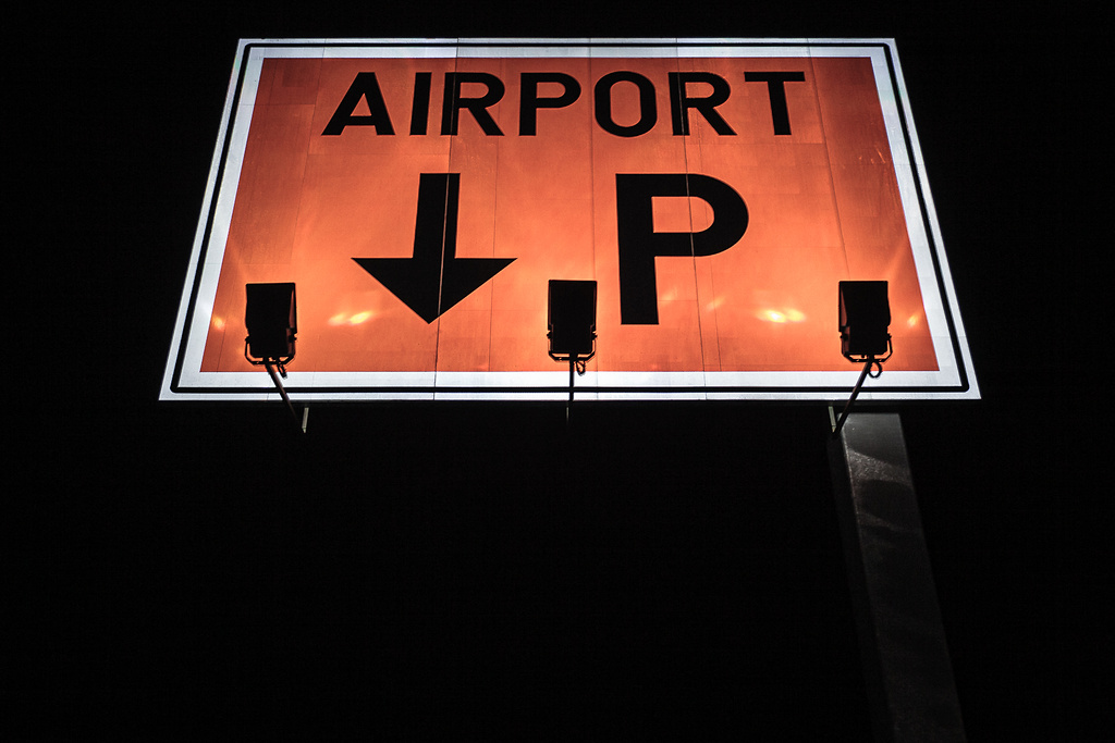 Panneau de parking illuminé dans la nuit.