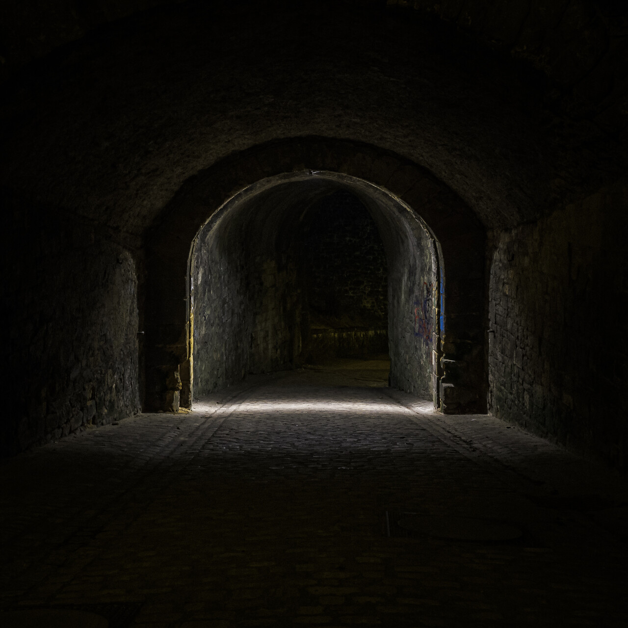 Porte médiévale du Pfaffenthal éclairée la nuit.